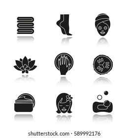 Spa salon drop shadow black icons set. Towels, woman's feet and face, cucumber slice, hand with manicure, cream jar, spa flower. Isolated vector illustrations