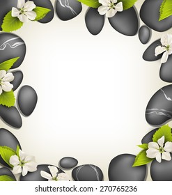 Spa stones with cherry white flowers like frame on beige background