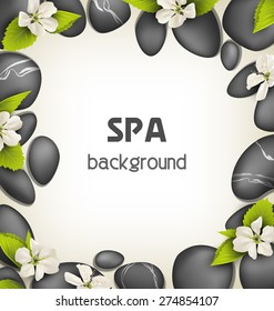 Spa stones with cherry white flowers like frame on beige background