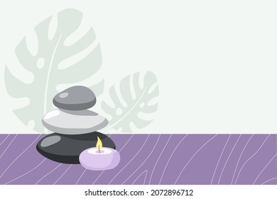 Spa time. Burning candle, stones on wooden table and monster leaves in fashionable modern style. Beauty spa treatment and relax concept for wellness, thai massage, meditation center, home spa.