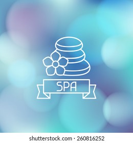 Spa wellness label on abstract blurred background.