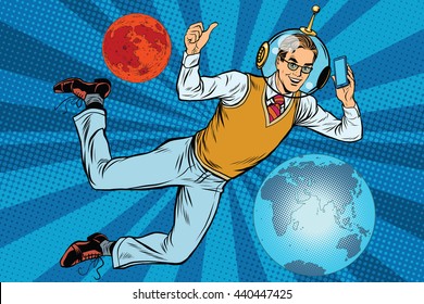 Space businessman with smartphone over the planet Earth and Mars pop art retro vector. New technology. science fiction. Male astronaut. Space business