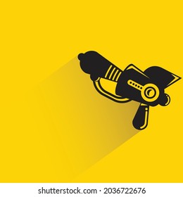 space gun with shadow on yellow background