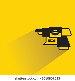 space gun with shadow on yellow background