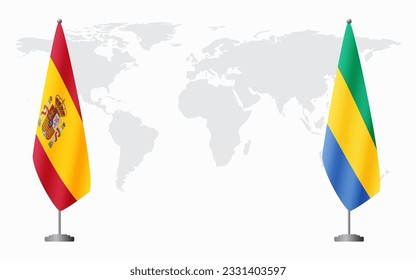 Spain and Gabon flags for official meeting against background of world map.