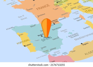 Spain with orange placeholder pin on europe map, close up Spain, vacation and road trip concept, pinned destination, travel idea, top view, colorful map with location icon