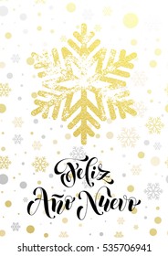 Spanish Happy New Year text Feliz Ano Nuevo of golden snowflake pattern. Hand drawn calligraphy lettering, glittering holiday greeting card. Gold glitter Christmas snow balls white premium background