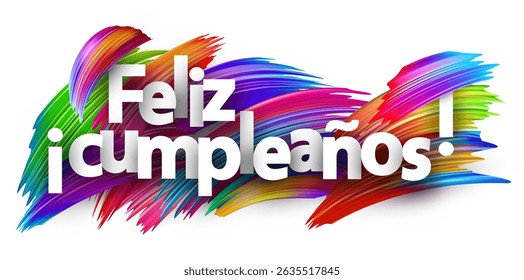 Spanish phrase for Happy Birthday displayed in bold white text over bright multicolored brush strokes
