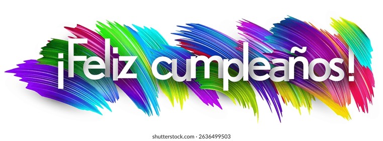 Spanish phrase for Happy Birthday written in white text on colorful paint strokes. Vector illustration.