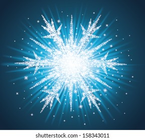 Sparkles in a shape of snowflake on the blue background.