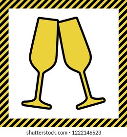 Sparkling champagne glasses. Vector. Warm yellow icon with black contour in frame named as under construction at white background. Isolated.