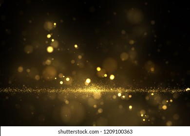 Sparkling gold particles on dark. Abstract luxury background