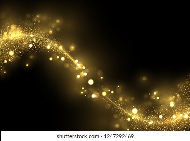Sparkling golden magic light on black. Glowing gold dust, shiny glittering effect. 