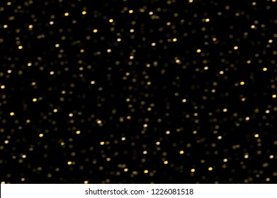 Sparkling golden particles abstract background 