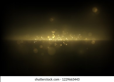 Sparkling golden particles on dark. Abstract luxury background