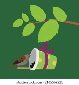 A sparrow sits on a cup feeder on a branch