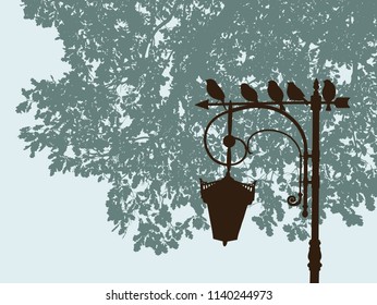 The sparrows sit on a lantern in a city park
