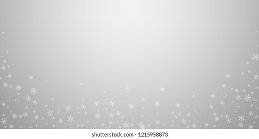 Sparse glowing snow Christmas background. Subtle flying snow flakes and stars on light grey background. Actual winter silver snowflake overlay template. Stylish vector illustration.