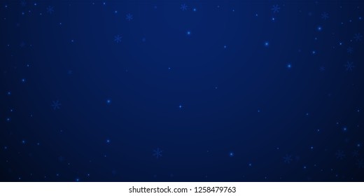 Sparse glowing snow Christmas background. Subtle flying snow flakes and stars on dark blue night background.