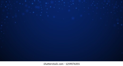 Sparse glowing snow Christmas background. Subtle flying snow flakes and stars on dark blue night background. 