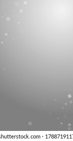 Sparse snowfall Christmas background. Subtle flying snow flakes and stars on grey background. Adorable winter silver snowflake overlay template. Extraordinary vertical illustration.