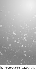 Sparse snowfall Christmas background. Subtle flying snow flakes and stars on grey background. Amusing winter silver snowflake overlay template. Graceful vertical illustration.