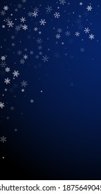 Sparse snowfall Christmas background. Subtle flying snow flakes and stars on dark blue background. Alluring winter silver snowflake overlay template. Vibrant vertical illustration.