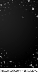 Sparse snowfall Christmas background. Subtle flying snow flakes and stars on black background. Admirable winter silver snowflake overlay template. Graceful vertical illustration.