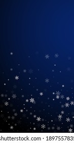 Sparse snowfall Christmas background. Subtle flying snow flakes and stars on dark blue background. Amusing winter silver snowflake overlay template. Ecstatic vertical illustration.