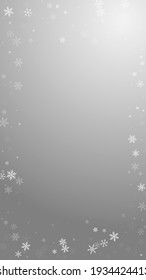 Sparse snowfall Christmas background. Subtle flying snow flakes and stars on grey background. Amusing winter silver snowflake overlay template. Astonishing vertical illustration.
