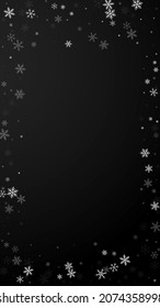 Sparse snowfall Christmas background. Subtle flying snow flakes and stars on black background. Amusing winter silver snowflake overlay template. Appealing vertical illustration.