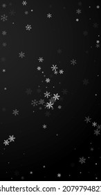 Sparse snowfall Christmas background. Subtle flying snow flakes and stars on black background. Alive winter silver snowflake overlay template. Actual vertical illustration.