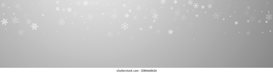 Sparse snowfall Christmas background. Subtle flying snow flakes and stars on grey background. Brilliant winter silver snowflake overlay template. Fresh panoramic illustration.