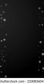 Sparse snowfall Christmas background. Subtle flying snow flakes and stars on black background. Adorable winter silver snowflake overlay template. Bold vertical illustration.