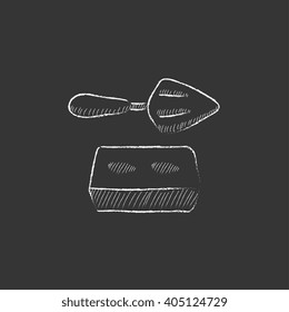 Spatula with brick. Drawn in chalk icon.