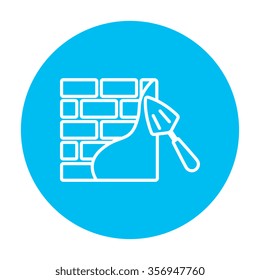 Spatula with brickwall line icon for web, mobile and infographics. Vector white icon on the light blue circle isolated on white background.