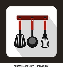 Spatula, ladle and whisk, kitchen tools on a hanger icon in flat style on a white background