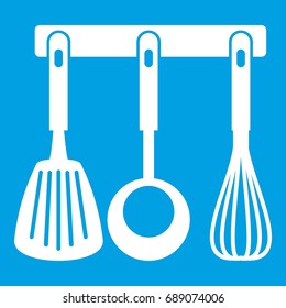 Spatula, ladle and whisk, kitchen tools on a hanger icon white isolated on blue background vector illustration