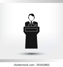  Speaker stands behind the podium