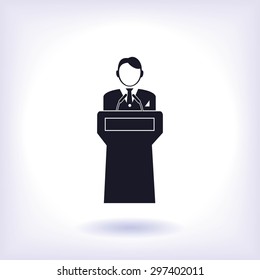  Speaker stands behind the podium