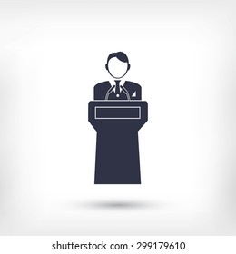  Speaker stands behind the podium