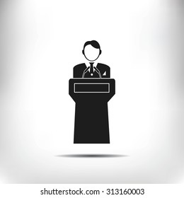  Speaker stands behind the podium