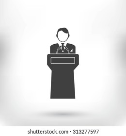  Speaker stands behind the podium