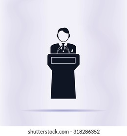  Speaker stands behind the podium