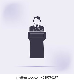  Speaker stands behind the podium