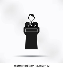  Speaker stands behind the podium
