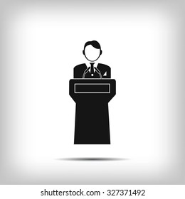  Speaker stands behind the podium