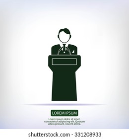  Speaker stands behind the podium