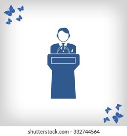  Speaker stands behind the podium