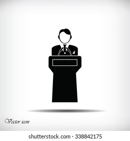  Speaker stands behind the podium